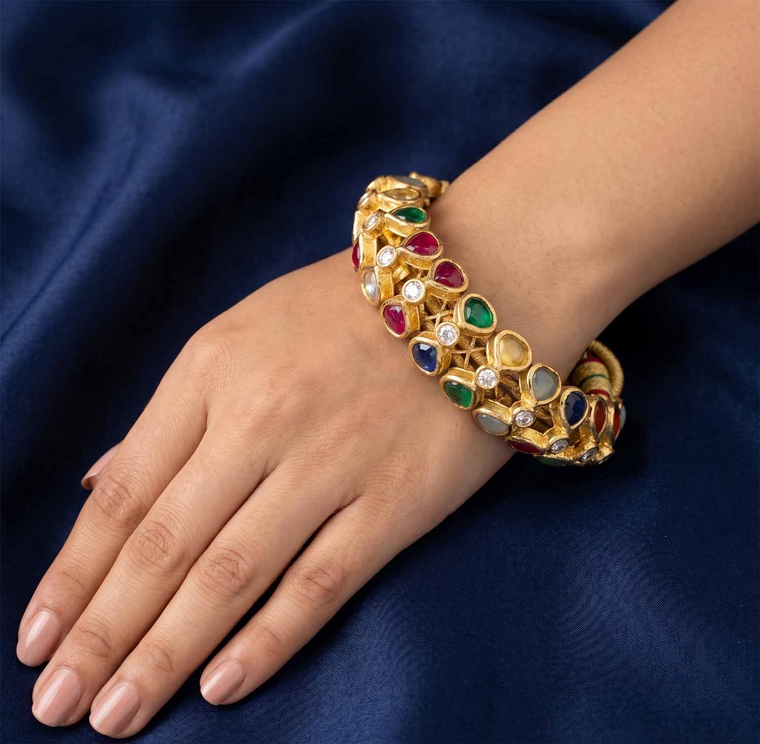 Traditional Navratna Polki bangle worn on a wrist for bridal jewellery inspiration