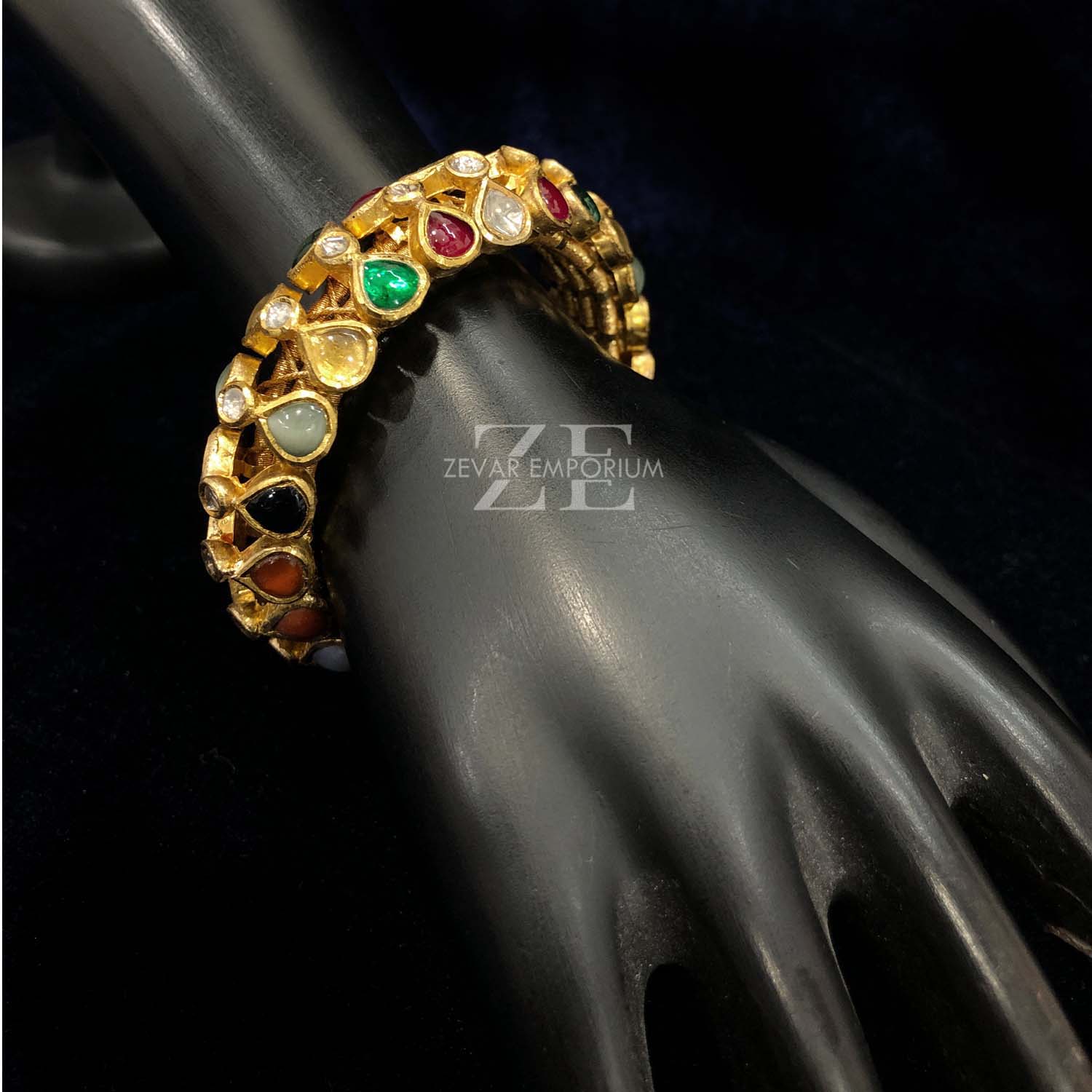18k gold flexible bangle studded with uncut diamonds and authentic navratna stones