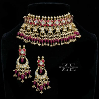 Ruby Polki Choker set in 18K Gold featuring a medium sized heritage collar and matching ruby chandbali earrings.