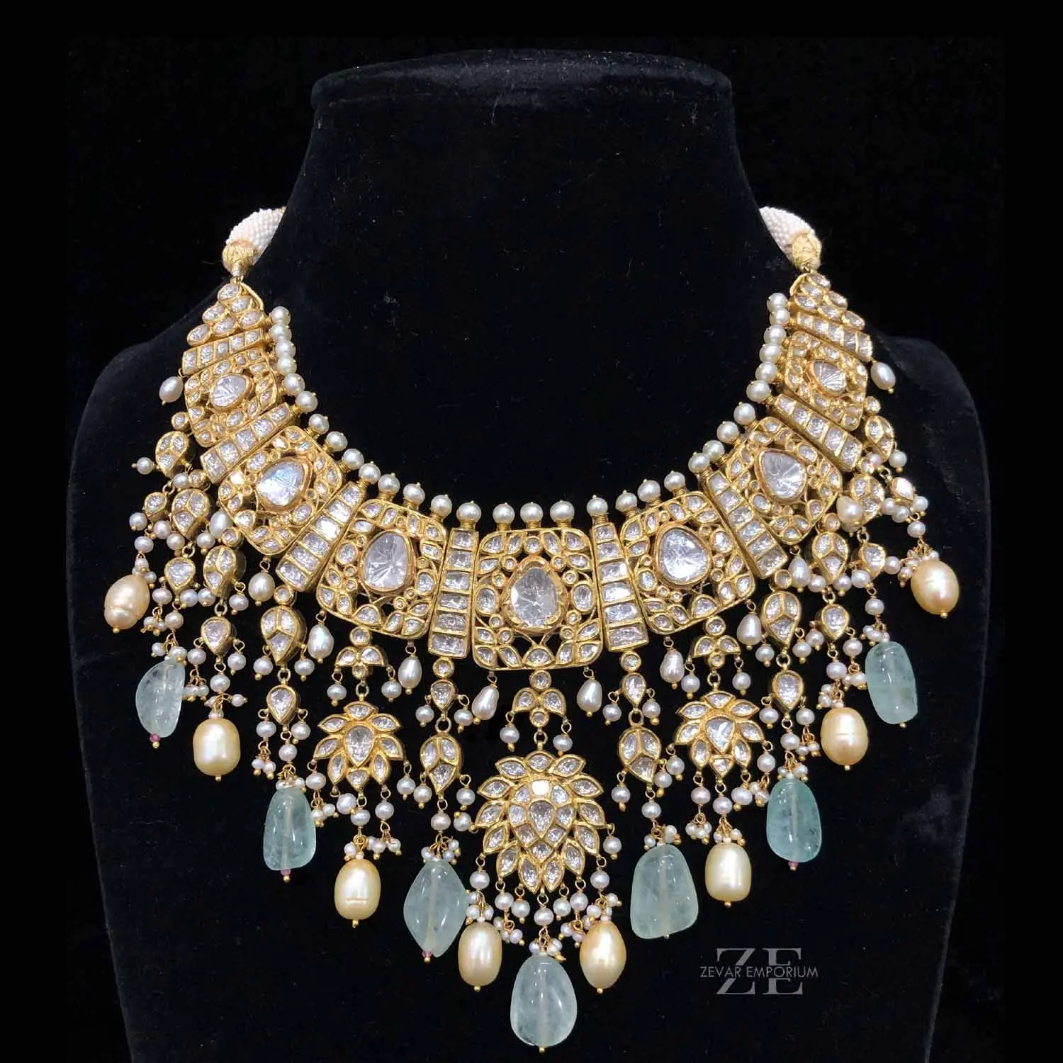 Front view of a heavy bridal Polki choker necklace with prominent uncut diamond settings and cascading pearls.