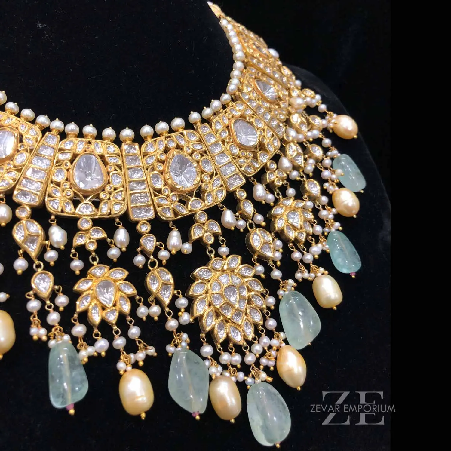 Macro detail shot of an intricate gold bridal choker showcasing big Polki stones and fine uncut diamond settings.