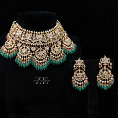 Polki Choker Set in 18K Gold featuring a grand 2 layered necklace with 5 hanging pendants and green beryl emerald drops.